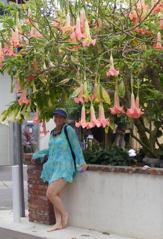 Lisa Beckley poses under a spectacular flowering tree during the land tour.